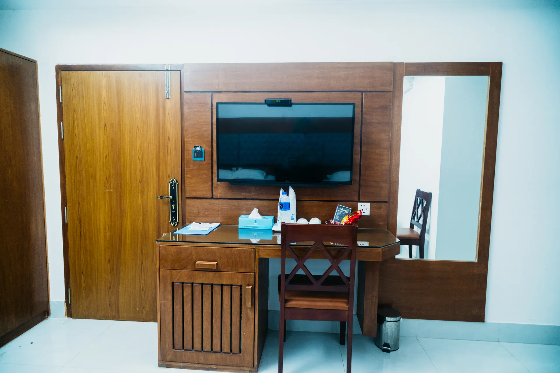 Sky Lawn Hotel guest room features a modern, elegantly designed space with a king-sized bed, tuft...