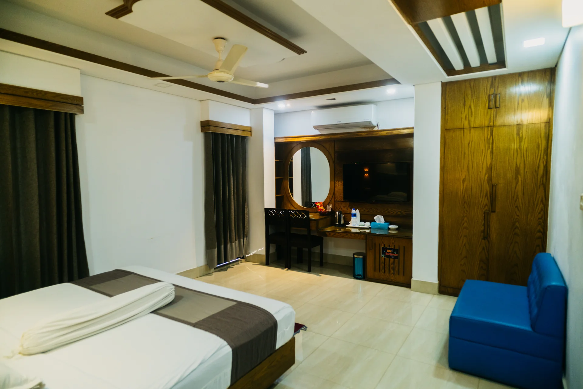 Sky Lawn Hotel’s guest room features a modern design with a distinctive circular ceiling motif (i...