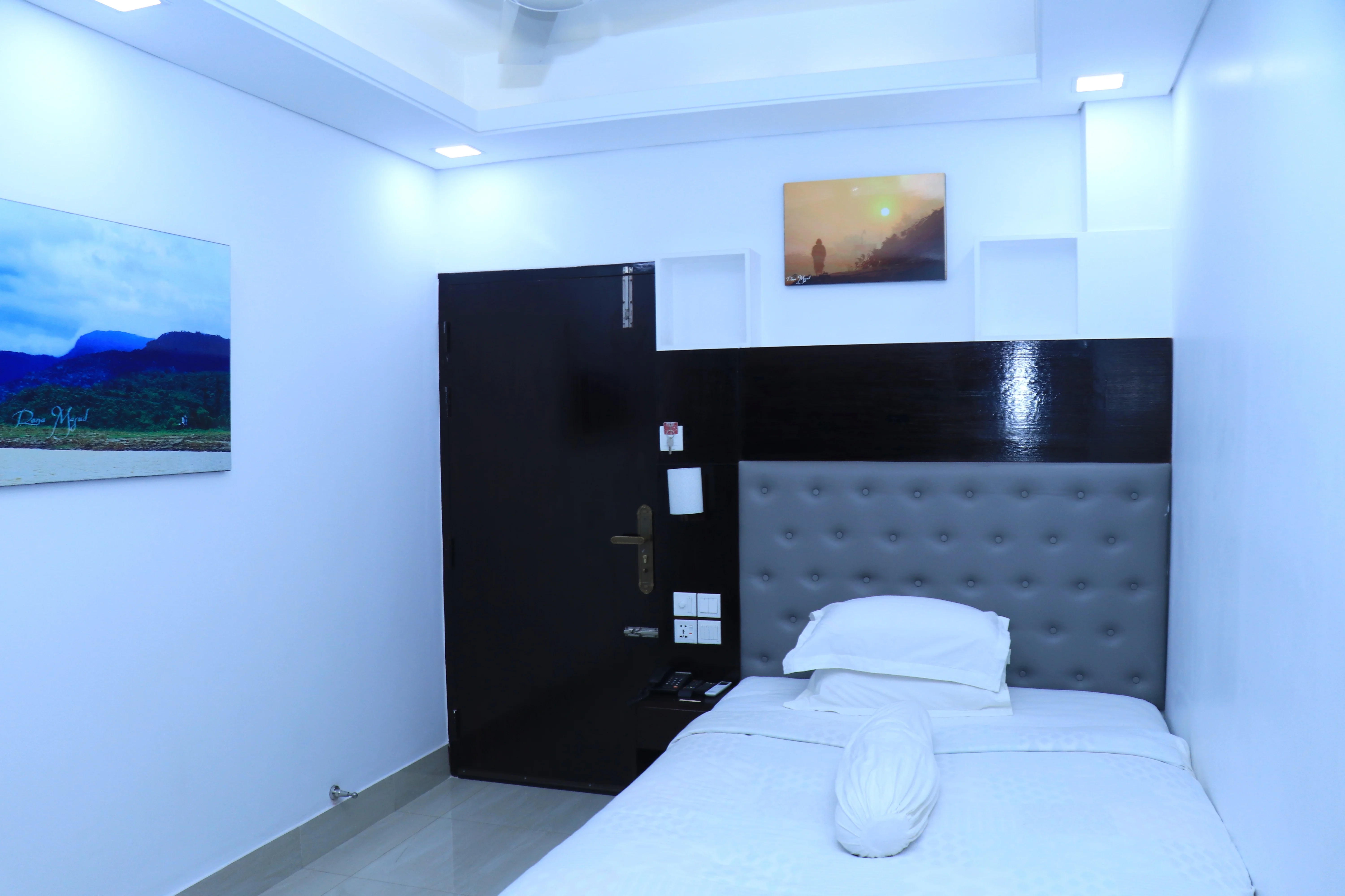 This Sky Lawn Hotel guest room features a cozy, warmly lit interior with rich wooden furniture, i...