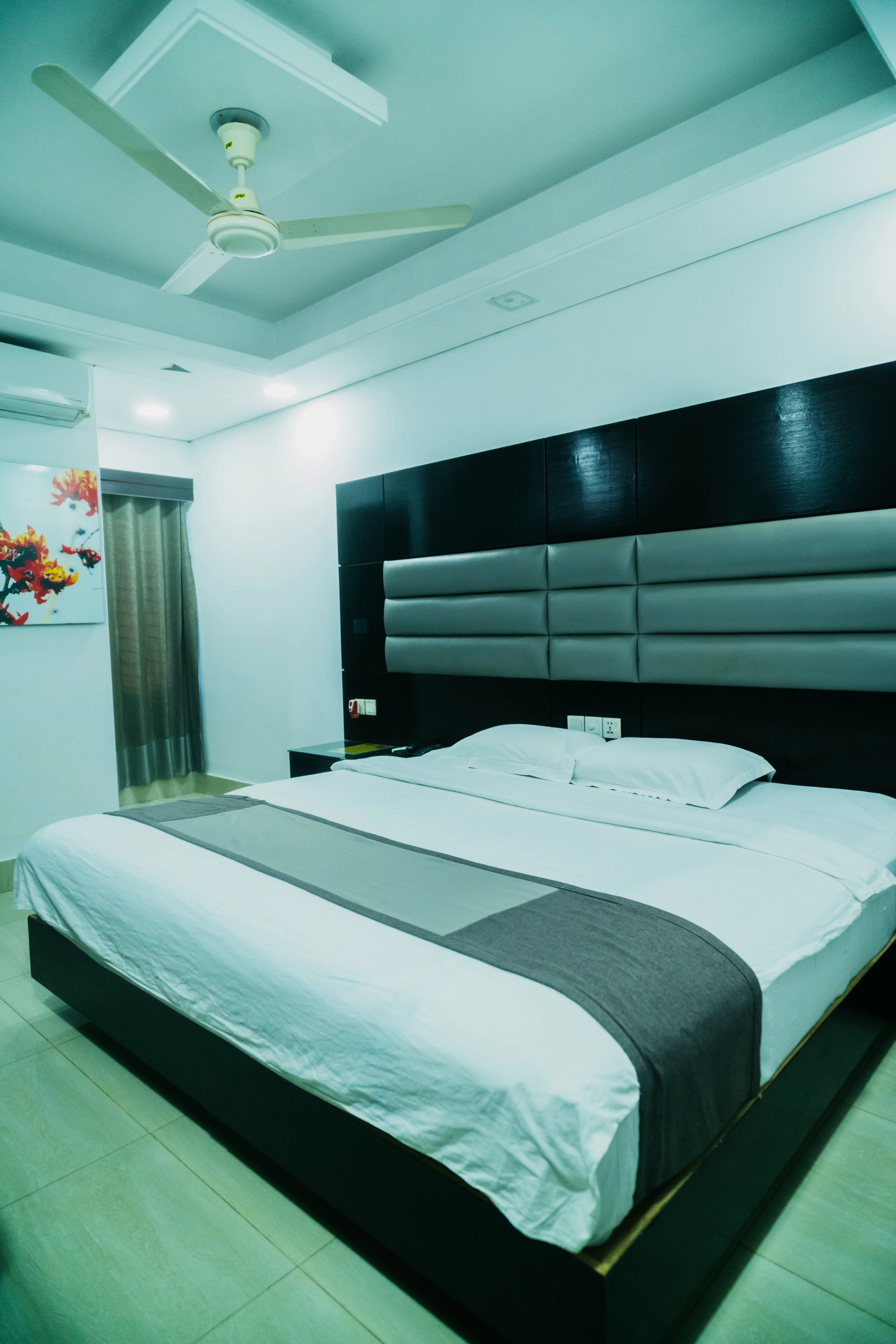 This Sky Lawn Hotel guest room features a cozy, warmly lit interior with rich wooden furniture, i...