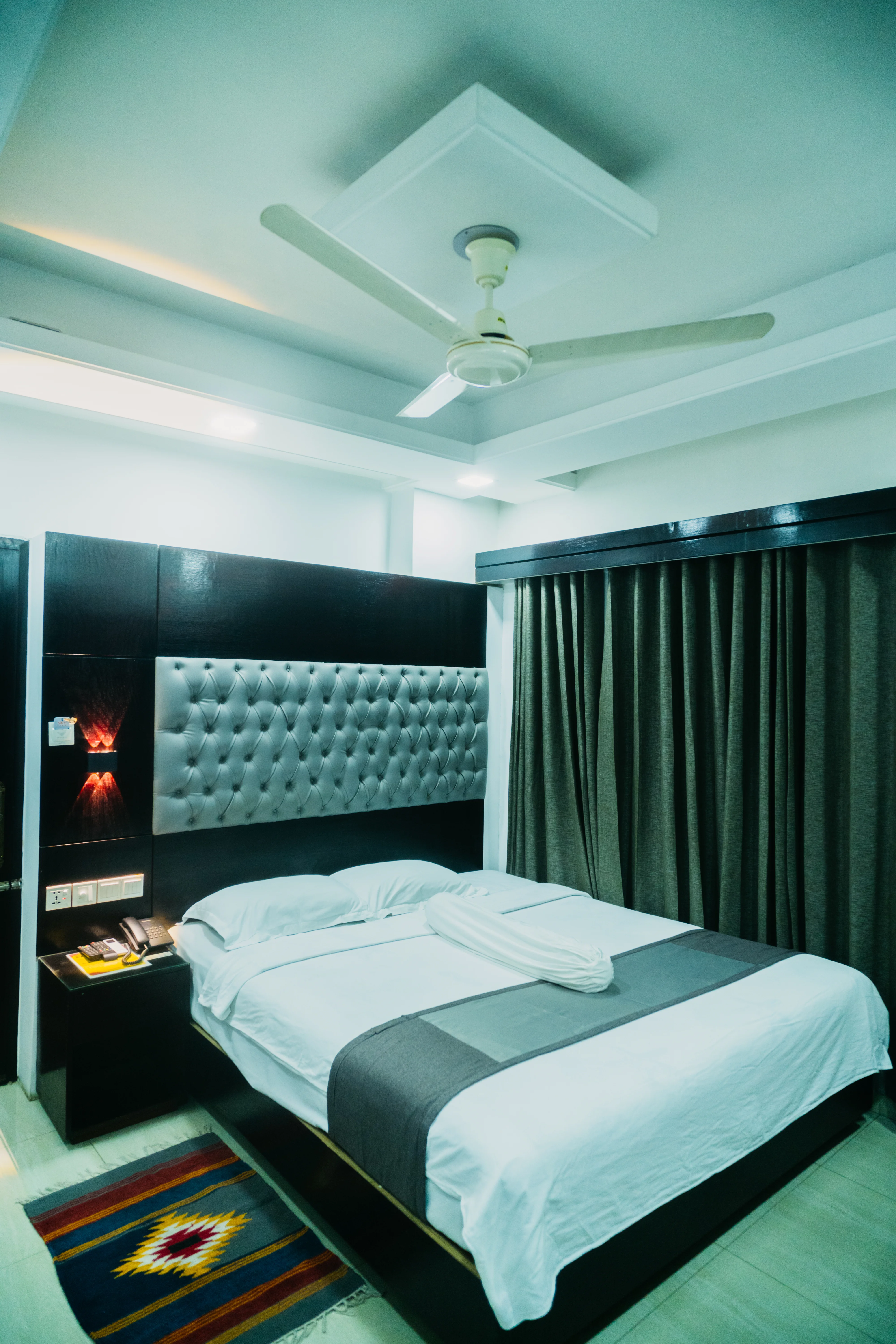 Sky Lawn Hotel’s guest room features a modern design with a distinctive circular ceiling motif (i...