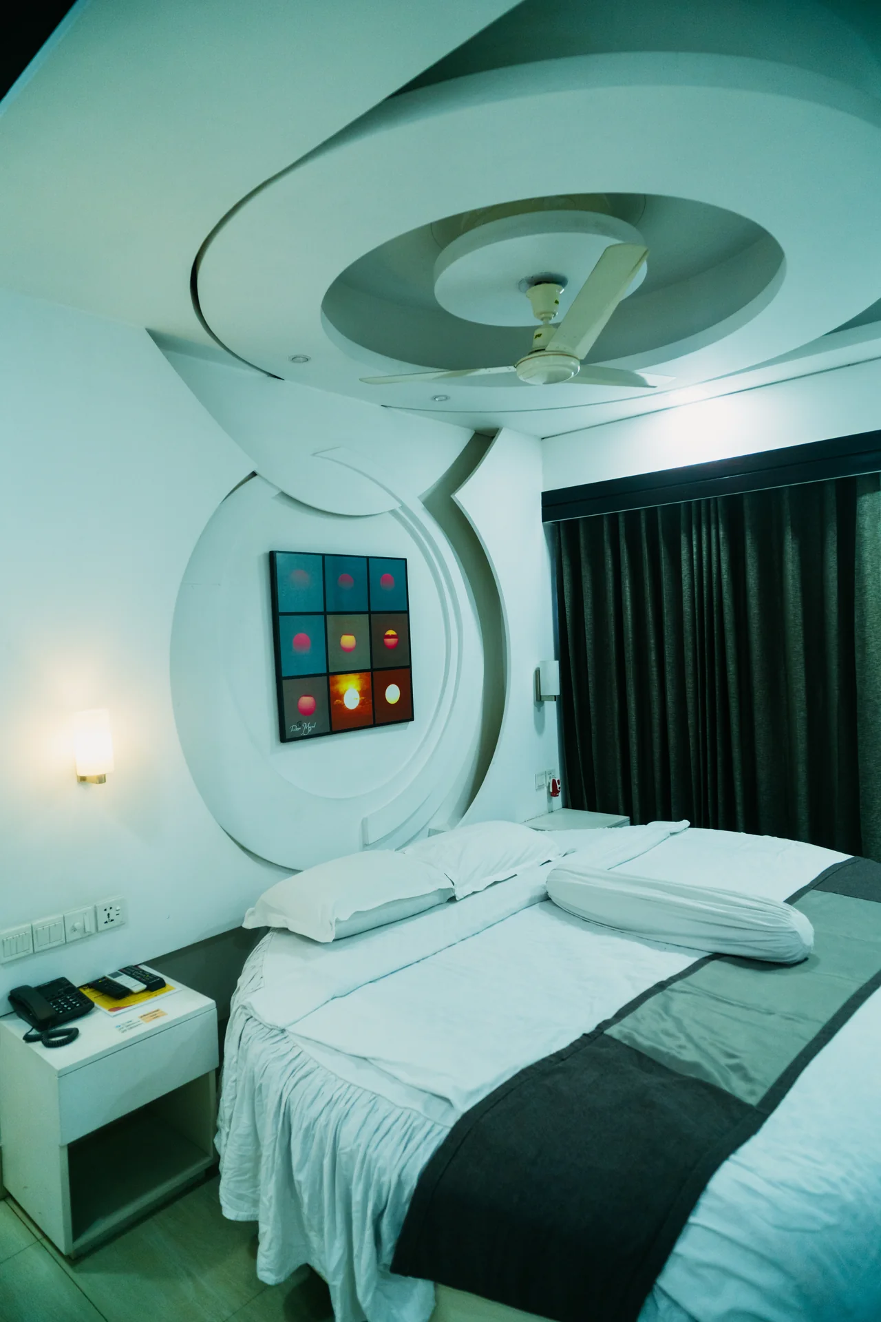 This Sky Lawn Hotel guest room features a cozy, warmly lit interior with rich wooden furniture, i...