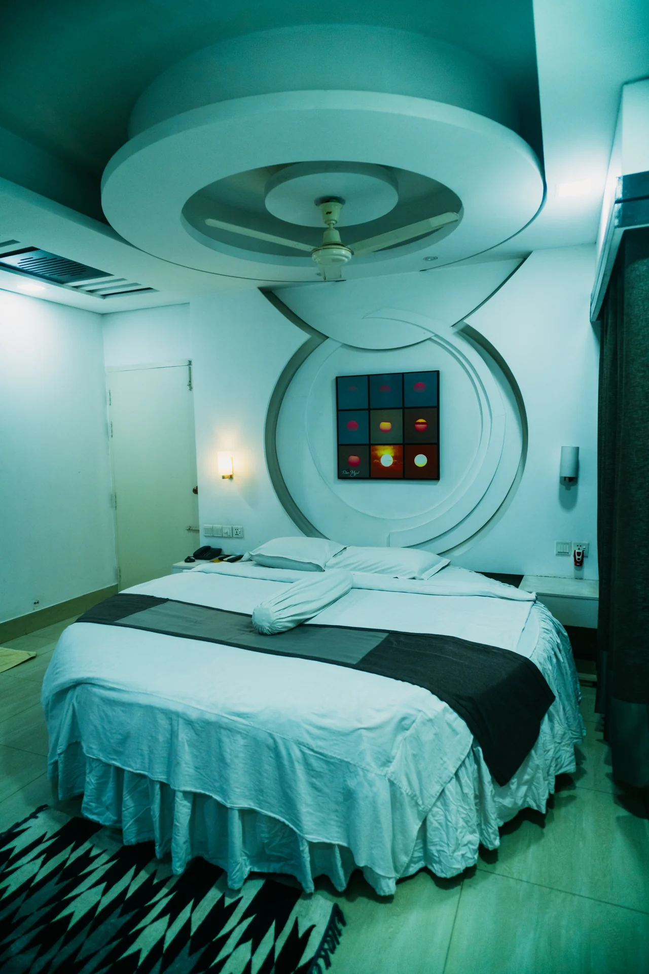 Sky Lawn Hotel’s guest room features a modern design with a distinctive circular ceiling motif (i...
