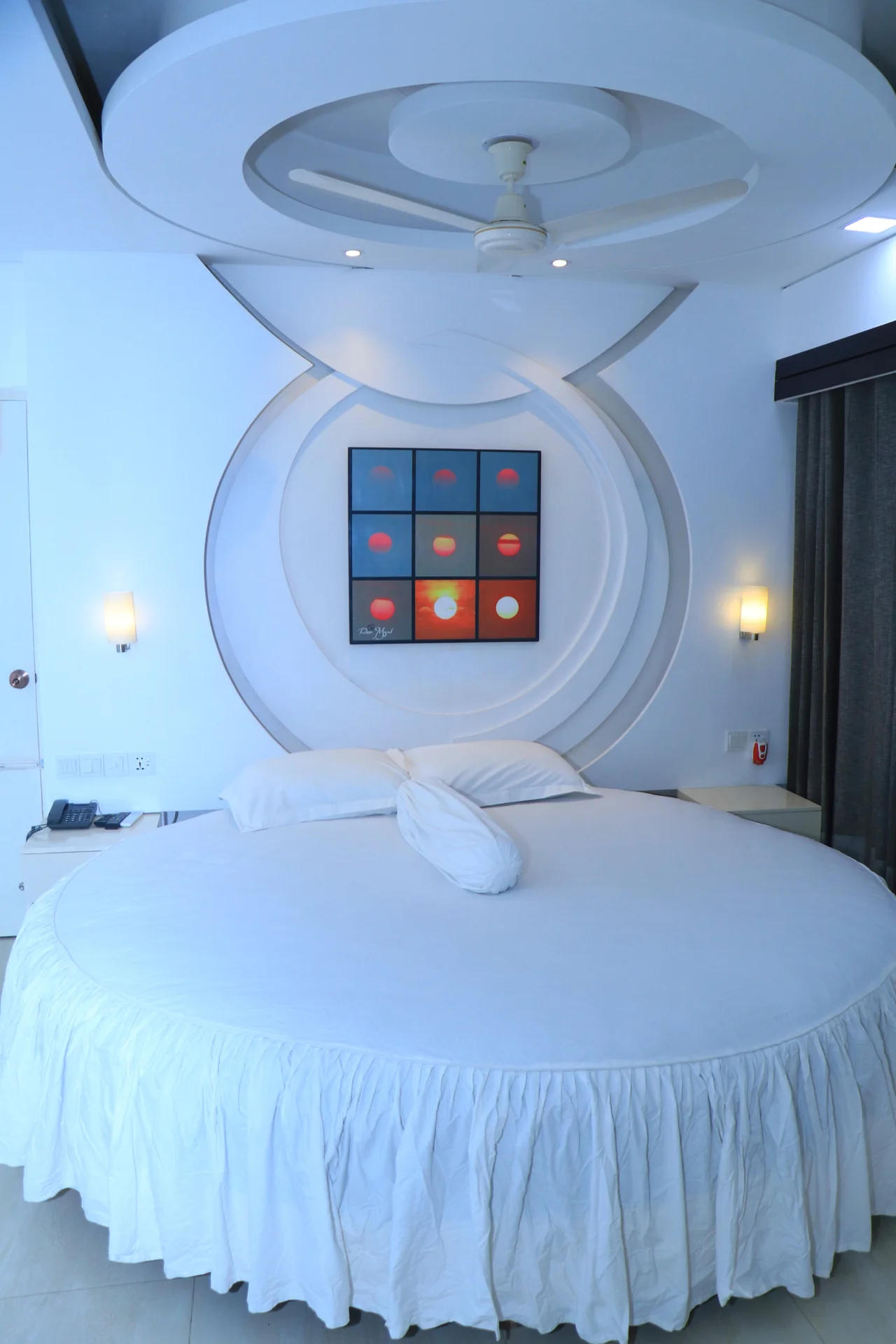 Sky Lawn Hotel’s modern guest room features a round bed with crisp white linens, a geometrically ...