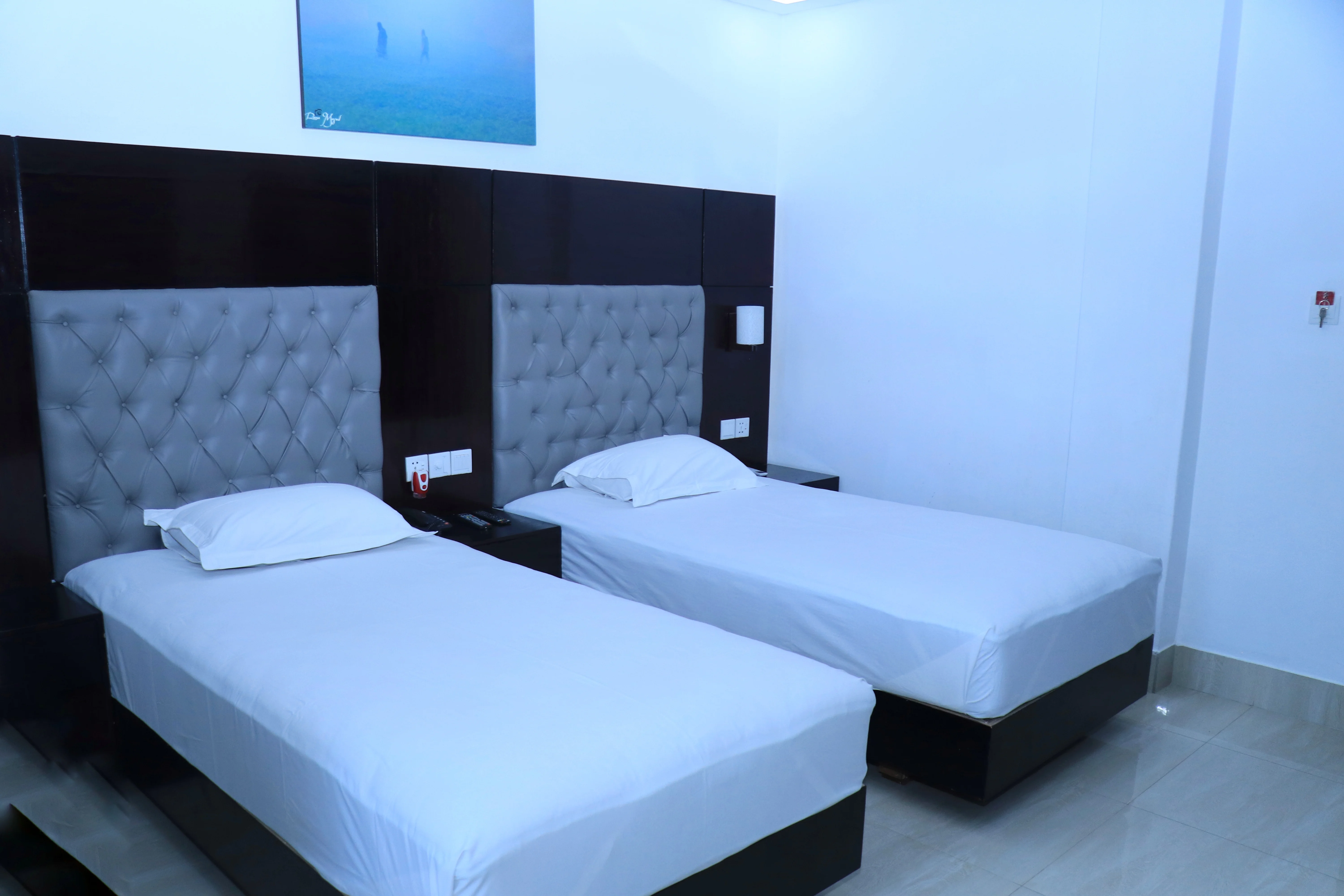 Sky Lawn Hotel's twin-bed guest room features two neatly made single beds with crisp white linens...
