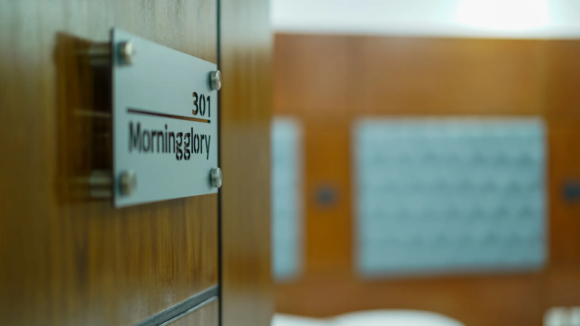 Sky Lawn Hotel's room 301 (named "Morningglory") features a polished wooden door with a metallic ...